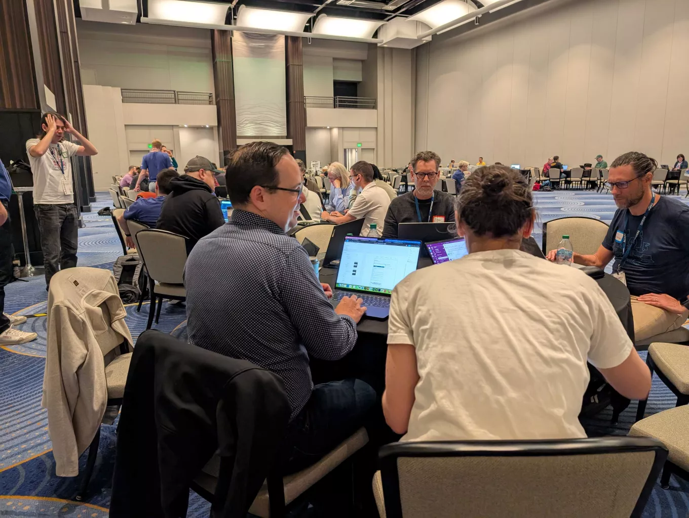 Tables of developers discuss how they can make Drupal better